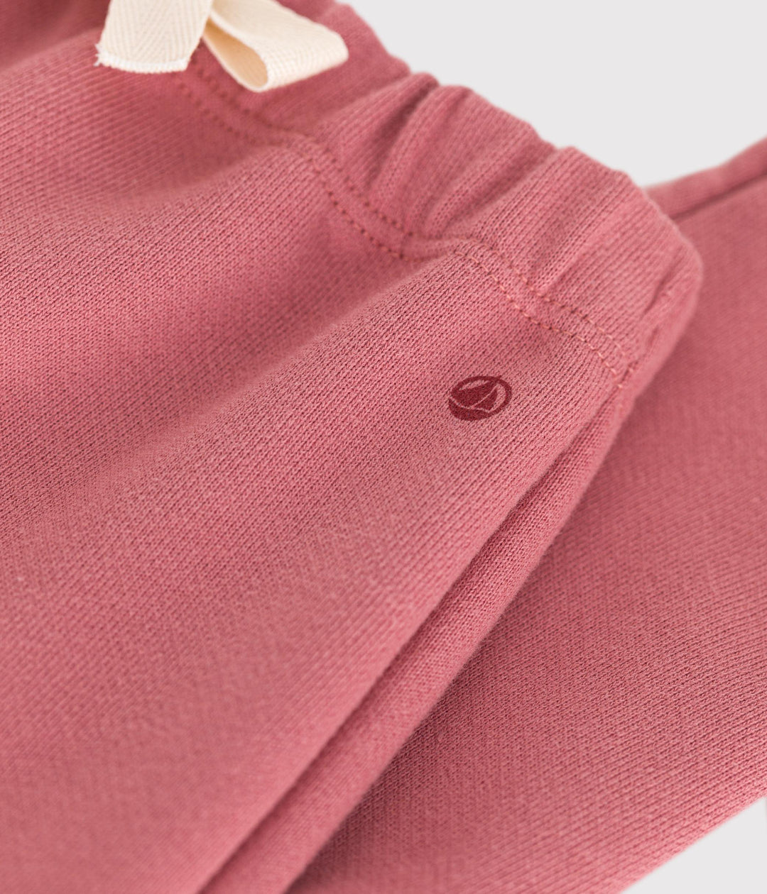 Pantaloni tinta unita rosa in tessuto felpato