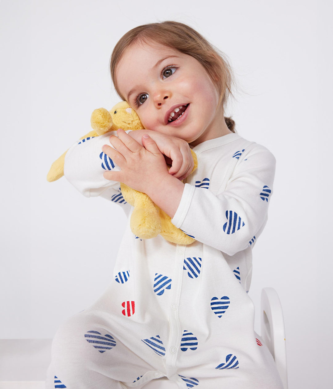Pigiama in cotone a righe con cuori neonato