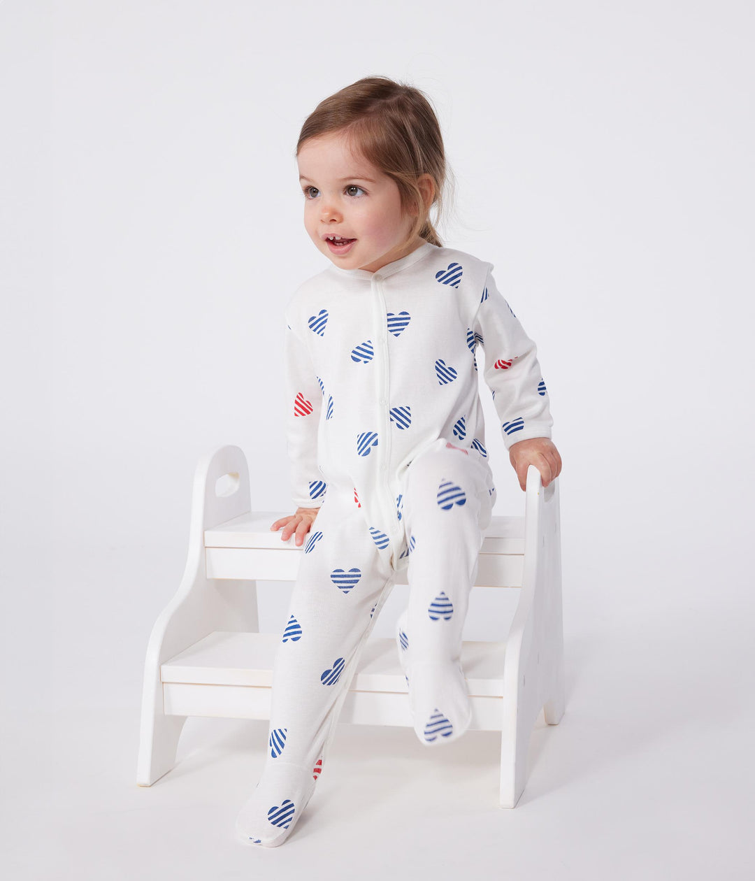 Pigiama in cotone a righe con cuori neonato